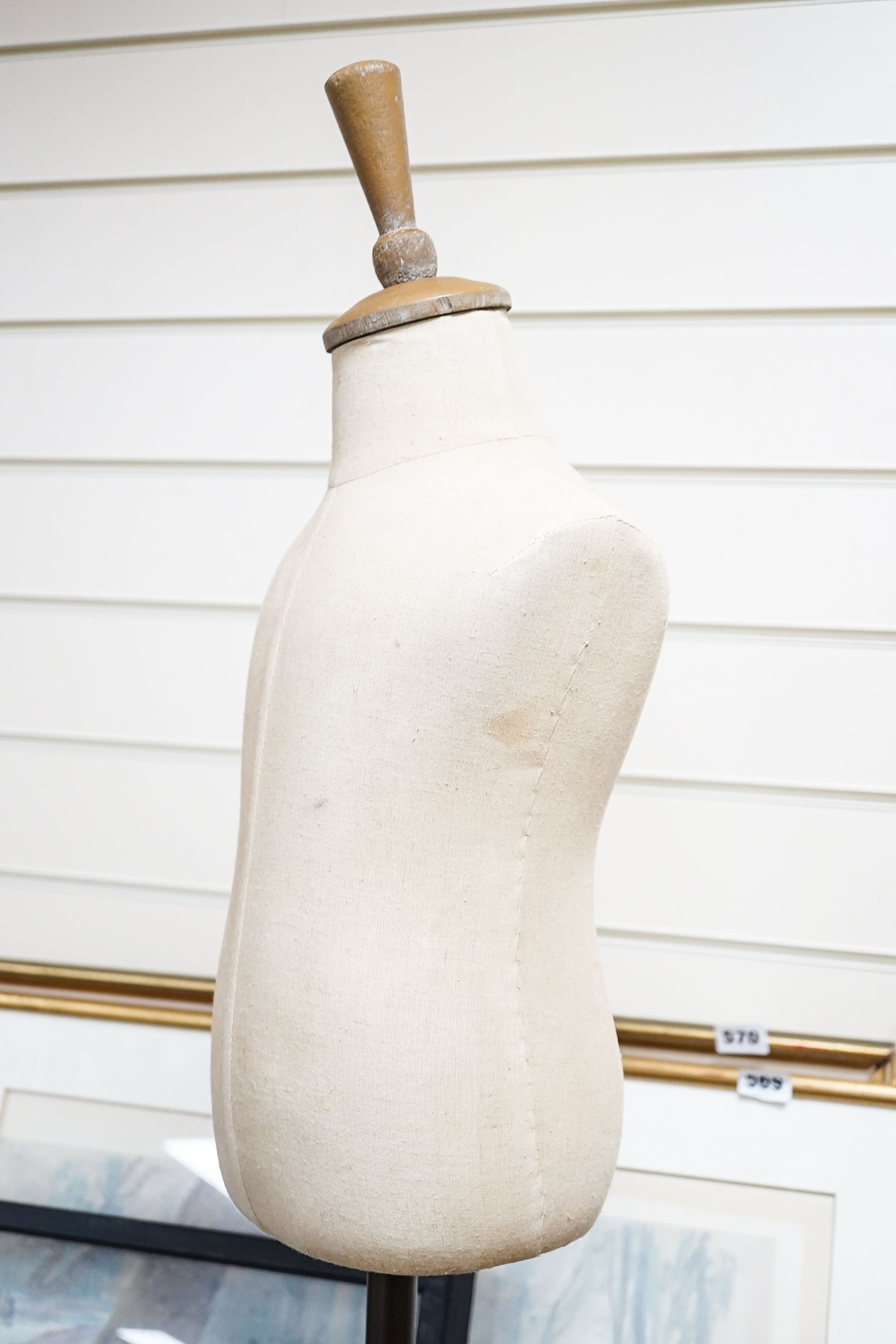A mannequin on cast iron stand, height 103cm, and a retailer's Thorne's Toffee can